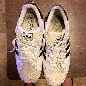 Used white adidas sneakers.